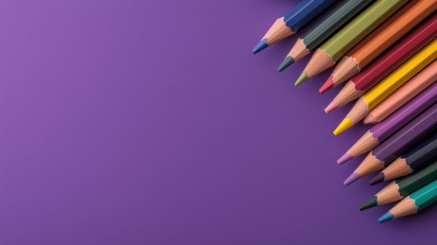Colored pencils on purple background. photo