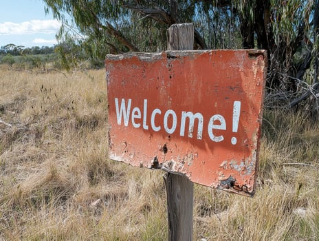 Rustic Welcome Sign in a Dry Field photo