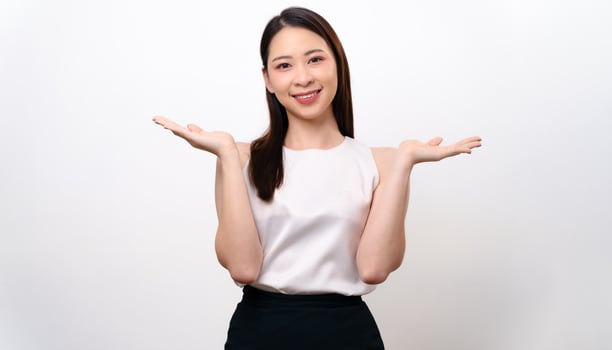 The portrait of beautiful young Asian woman hands up to product present, or showing something photo
