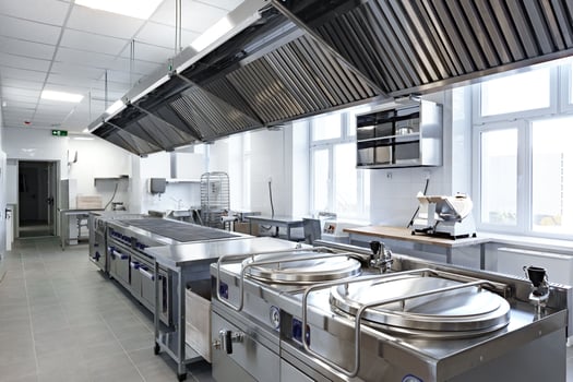 Modern commercial kitchen featuring stainless steel equipment and ample workspace photo