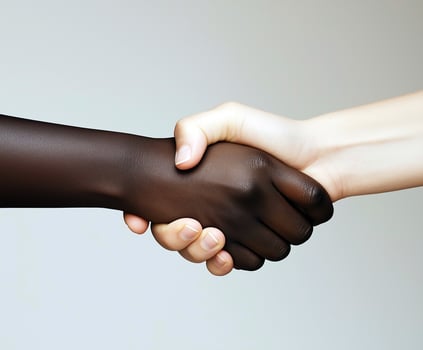 handshake close-up on white background, black and white man shaking hands, concept of teamwork, world without racism photo