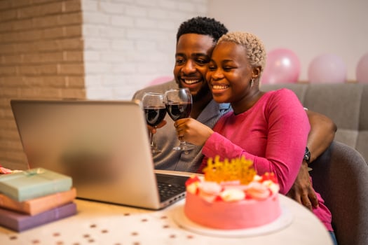 Happy couple having online call with family for birthday photo