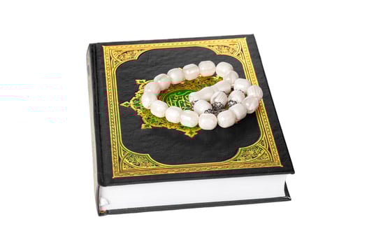 Islamic Book Holy Quran and beads on withe background photo
