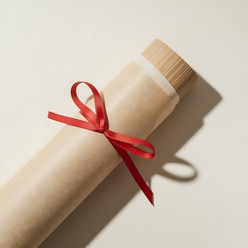 A gift wrapped in paper tied with a red ribbon perfect for business needs and branding photo