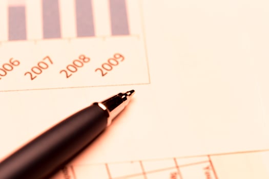 Business charts and pen photo