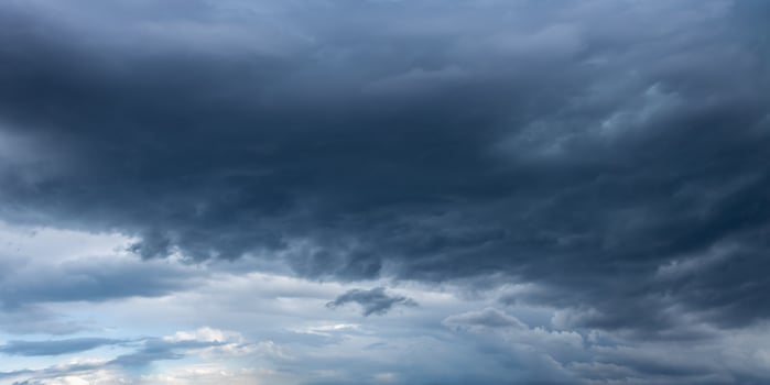 Dark storm clouds gathering in the sky, creating ominous atmosphere photo