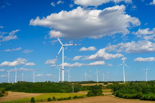 A stunning wind farm with large turbines generating clean renewable energy in a rural landscape. photo