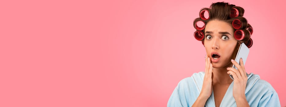 Shocked Housewife Talking On Phone Listening To Shocking Rumors Standing On Yellow Studio Background. Panorama, Copy Space photo