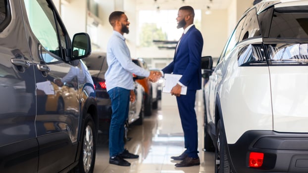 Auto Showroom Manager Shaking Hands With Male Customer After Successful Deal, Young African American Man Buying Car In Modern Dealership Center, Handshaking With Salesperson, Selective Focus photo