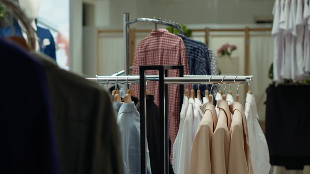 Trendy clothing racks displaying a variety of chic fashion items in a mall store, offering a stylish shopping experience and a selection of fashionable pieces for modern trendy wardrobes. photo
