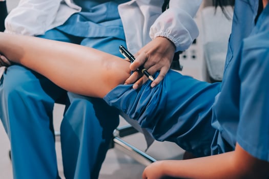 A doctor is examining a patient's leg photo