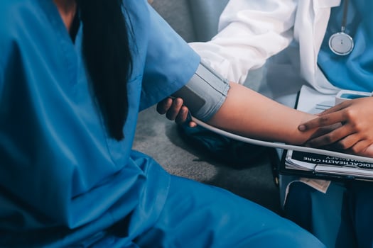 A doctor checking the blood pressure of a patient photo