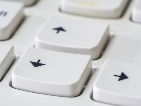 Close up of arrow keys on white keyboard of modern laptop photo