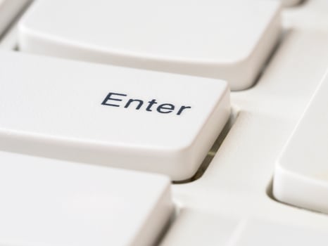 Close up of Enter keys on white keyboard of modern laptop photo