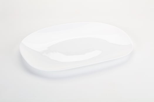 A white plate with a curved edge photo