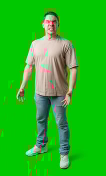Man expressing intense frustration while standing against a bright green background photo