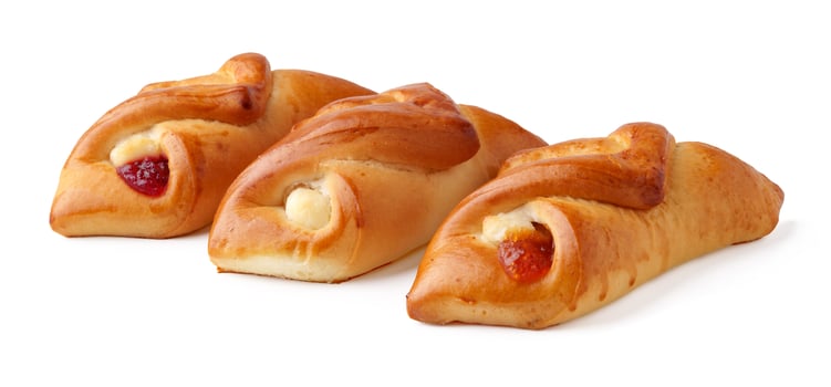Delicious bakery sweets with fruit filling displayed on a clean white surface ready to enjoy for breakfast or snacks photo
