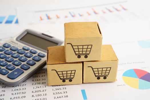 Online shopping, Shopping cart box on calculator, import export, finance photo