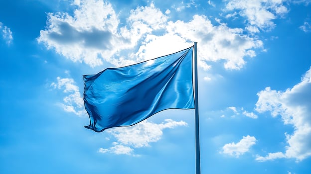 Vibrant blue flag waving under bright sunny sky during daytime photo