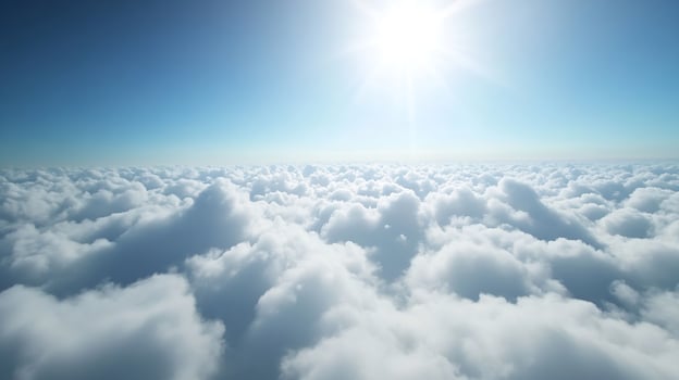 Serene Aerial View of Sunlit Clouds Stretching into the Clear Blue Sky photo
