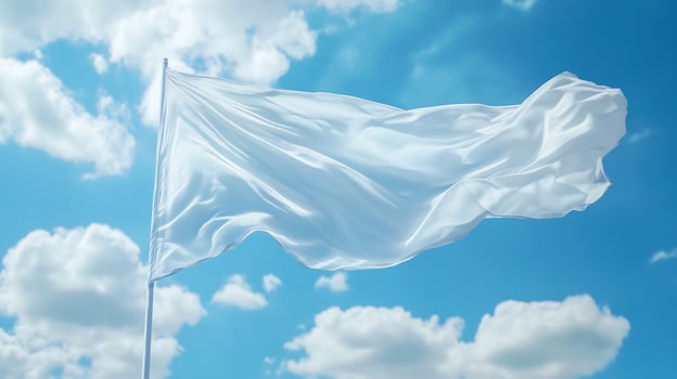 White Flag Waving Against a Clear Blue Sky with Fluffy Clouds photo