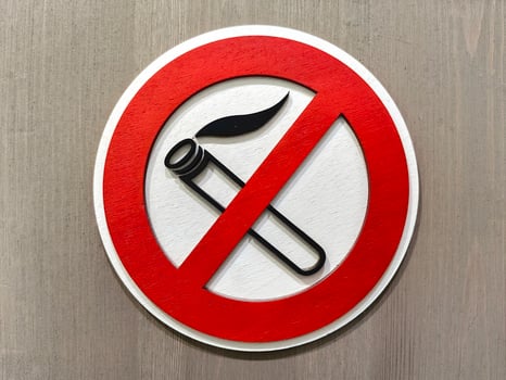 Close up of no smoking sign displayed on a wooden wall emphasizing the importance of a smoke-free environment photo