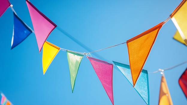 Vibrant Colorful Fabric Bunting Flags Against a Clear Blue Sky for Celebrations and Outdoor Festivities photo