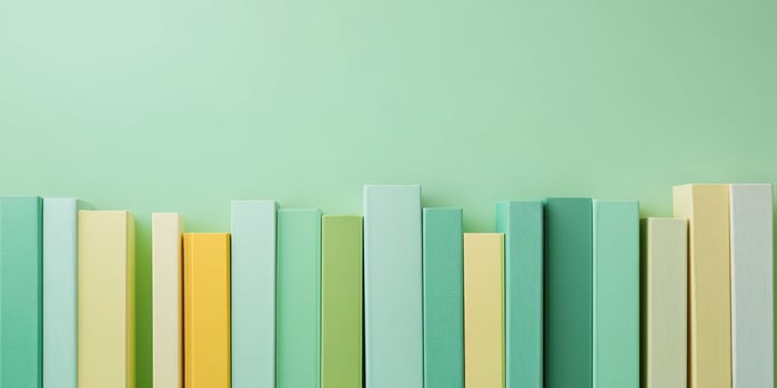 Colorful vertical books in green and yellow tones against soft background photo