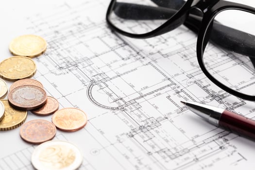 architect house plane and coins, investment in new home concept photo