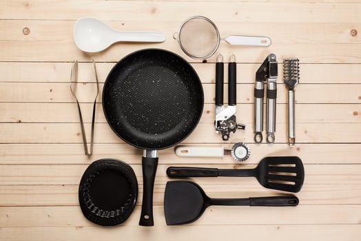 cookware and accessories on a wooden table. photo