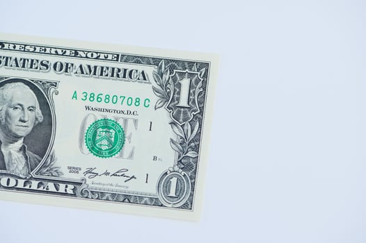 One dollar bill placed on a clean white background highlighting its design and details photo