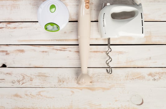 Various kitchen utensils on wooden table photo