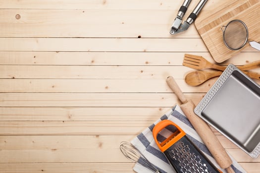 cookware and accessories on a wooden table. photo