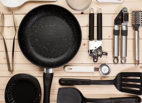 cookware and accessories on a wooden table. photo