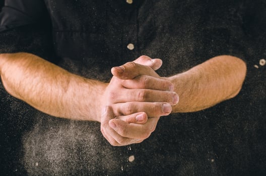 hand clap and white flour on black background photo