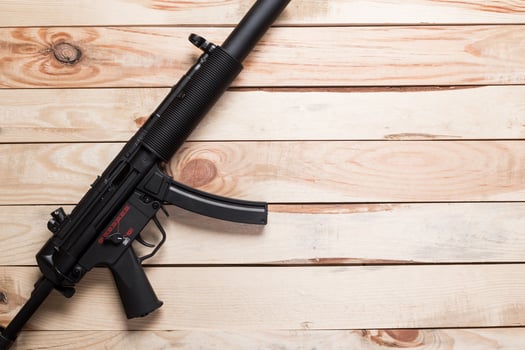 black semi-automatic gun on old wood background. photo