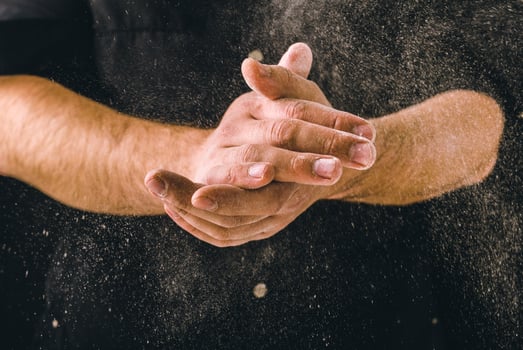 hand clap and white flour on black background photo