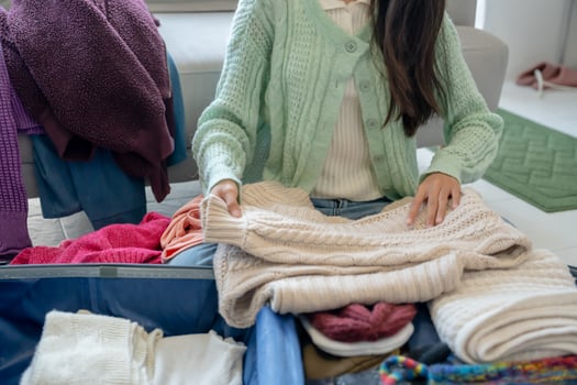 asian Woman packing suitcase for travel planning preparing vacation in winter. photo