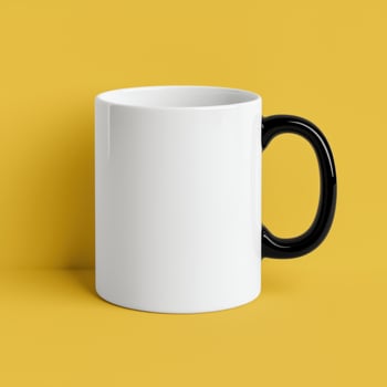 A plain white mug with black handle on yellow background photo