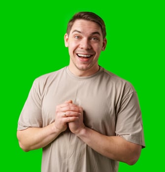 A cheerful man with a friendly smile poses against a bright green background photo