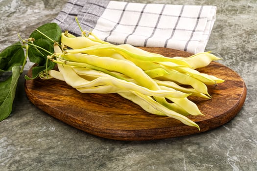 A bunch of beans on a wooden cutting board photo