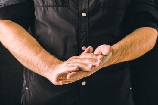 hand clap and white flour on black background photo