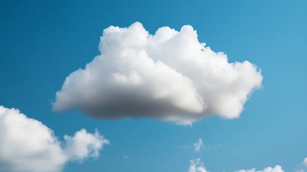 Isolated White Fluffy Cloud Against a Vivid Blue Clear Sky on a Sunny Day photo