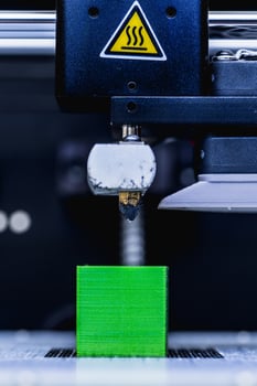 head of 3d printer in action photo