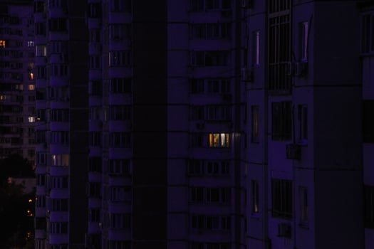 A blurry night picture of a building with purple window lights photo