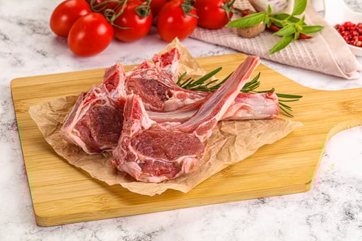 A cutting board with meat and vegetables on it photo