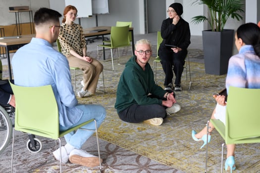 Corporate business team meeting with a manager or coach. Group of happy diverse, multiracial people sitting in a circle photo