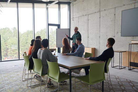 A diverse multiethnic business team engages in a collaborative meeting, discussing strategies and solutions in a modern office setting photo