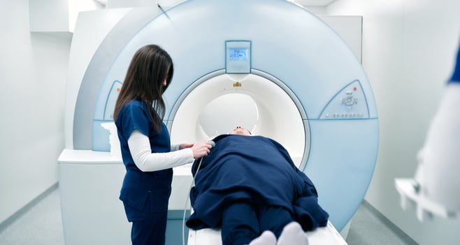 A nurse or medical technician prepares a patient for an MRI scan or MRI scanner photo