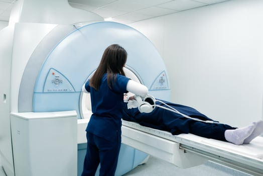 A nurse or medical technician prepares a patient for an MRI scan or MRI scanner photo